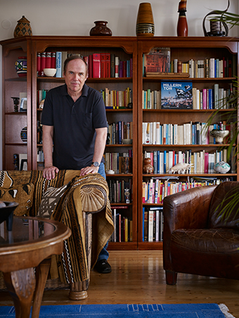 A man standing behind a chair