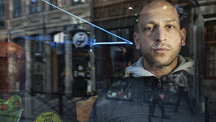 A man behind a glass storefront
