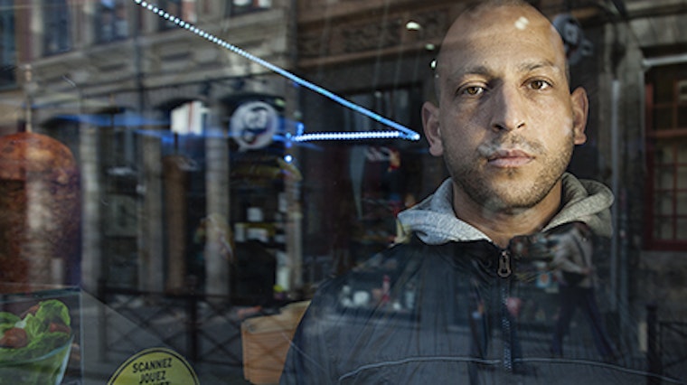 A man behind a glass storefront
