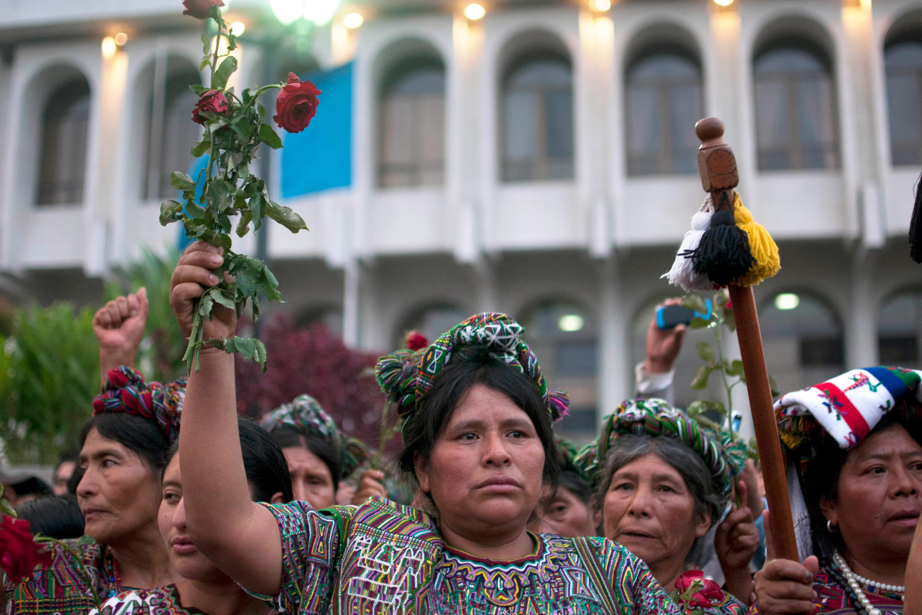 A woman holding flowers in protest