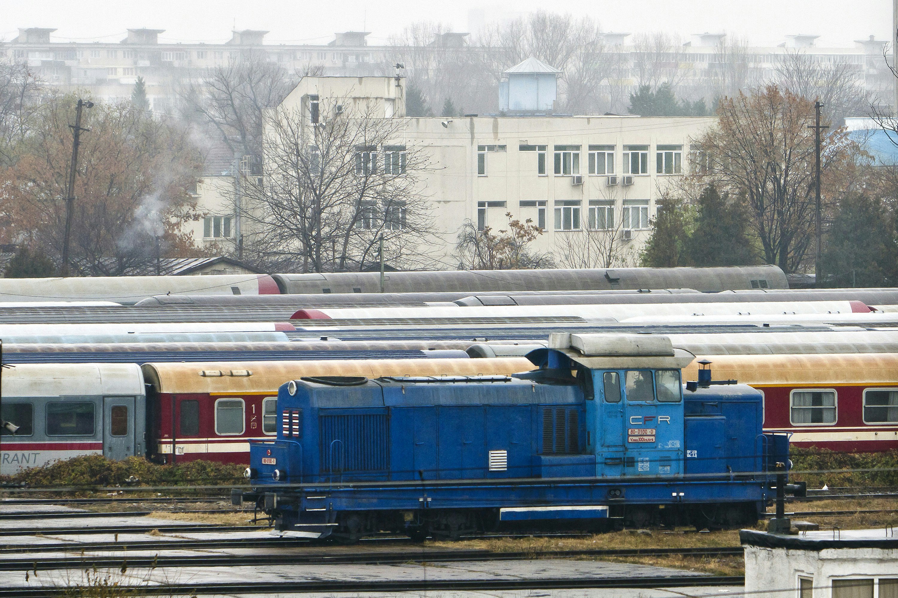 A railway yard with a building in the background