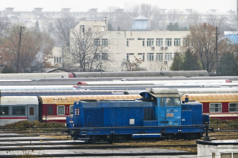 A railway yard with a building in the background
