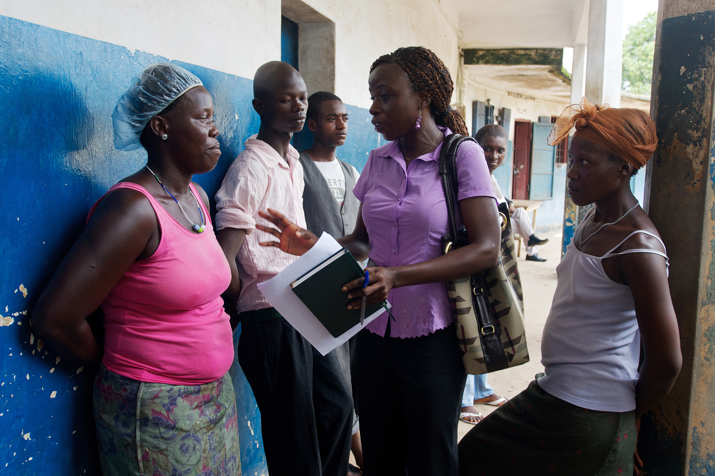 A woman speaking to a small group of people