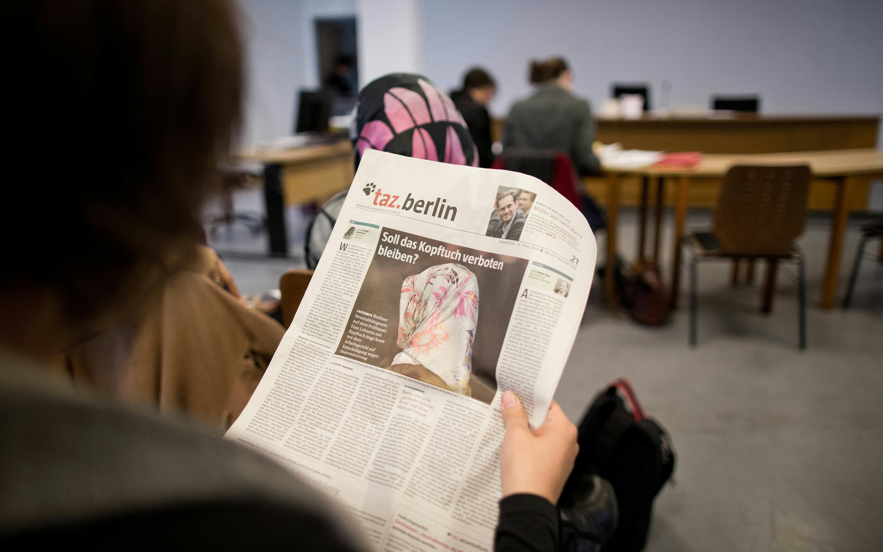 A woman reading a German newspaper